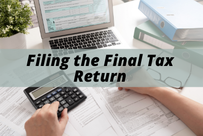 filing taxes at desk with computer and calculator