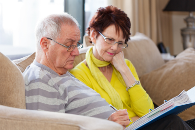 an elder couple looking at papers